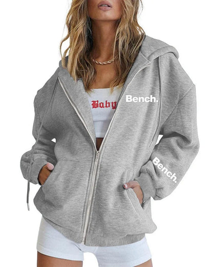 Grey loose fit men's sweater coat with a front zipper, modelled casually.
