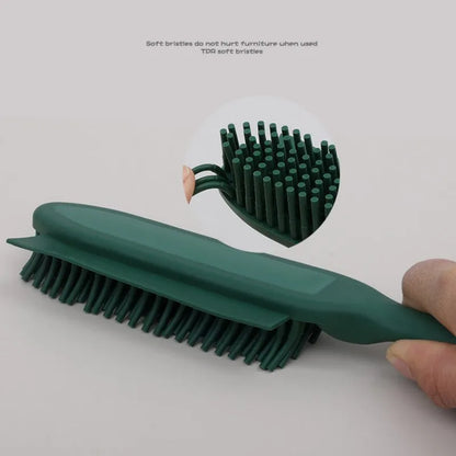 Green silicone pet grooming brush with flexible bristles for removing hair from cats, dogs and furniture