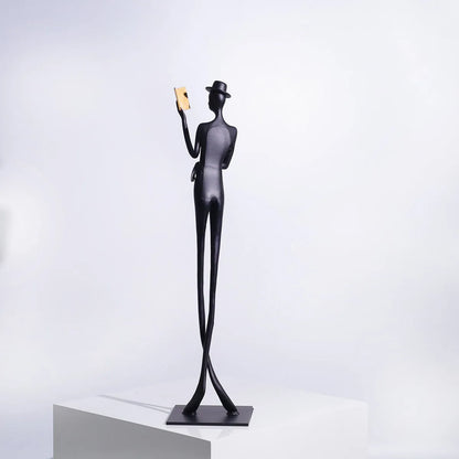 Black cast aluminium desktop sculpture of reading woman measuring 12x12x51cm with modern simplicity design
