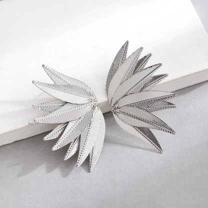 Gold and white alloy leaf-shaped patch earrings with dangle design