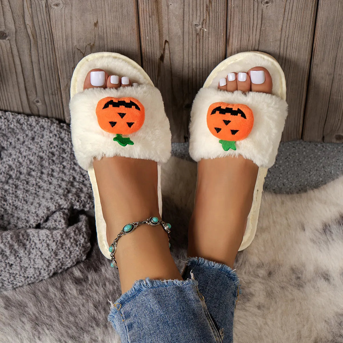 Yellow Halloween pumpkin plush open-toe slippers with synthetic fur and a light grey PVC anti-slip sole.