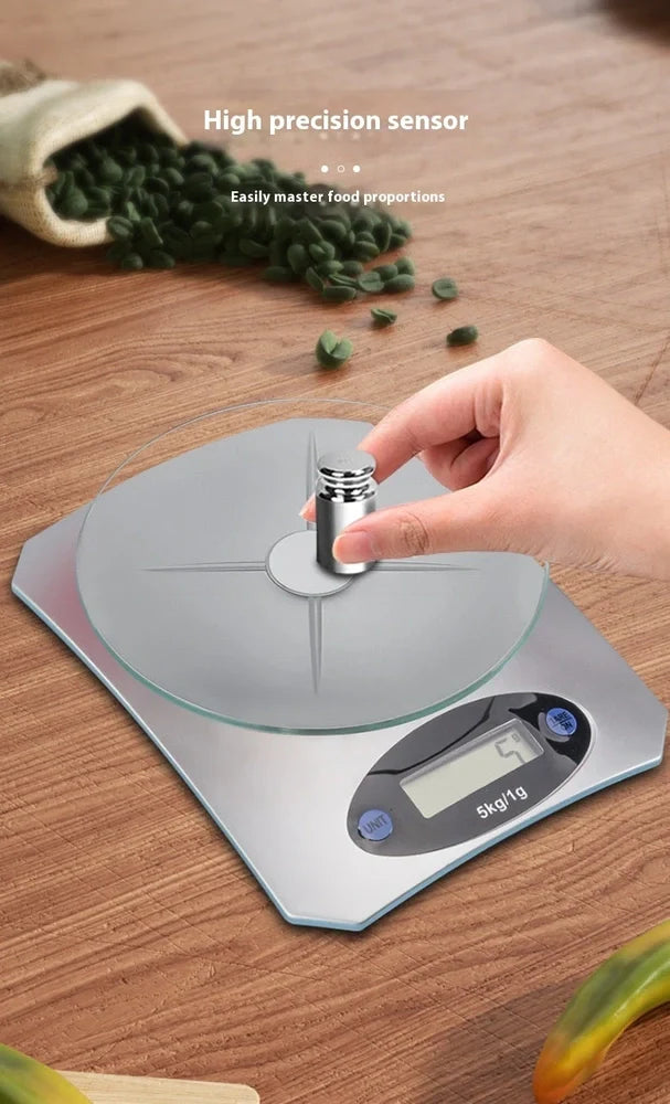 Silver white mini electronic kitchen scale with digital display showing 0.1g precision measurements