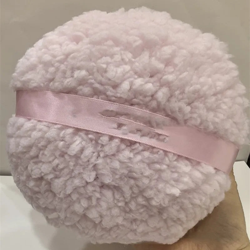 Oversized plush dry puff for makeup powder application in white colour, measuring 150mm by 75mm
