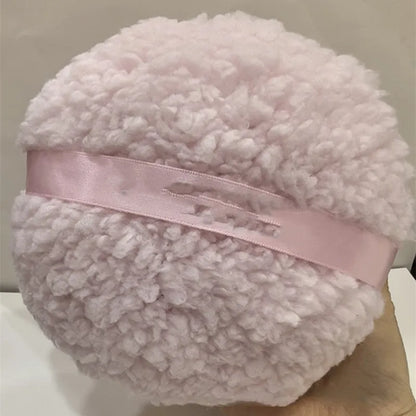 Oversized plush dry puff for makeup powder application in white colour, measuring 150mm by 75mm