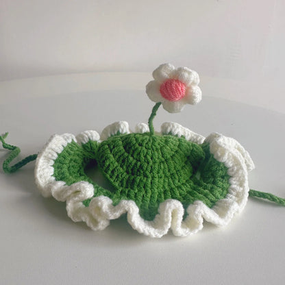Green knitted cat hat on a kitten, showing soft fabric and cute design for parties.