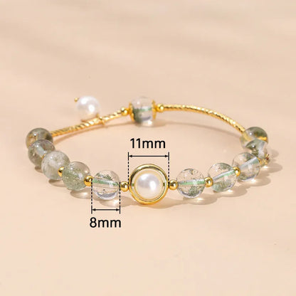 Close-up of a manually crafted crystal agate bracelet with shaped animal and fruit beads.