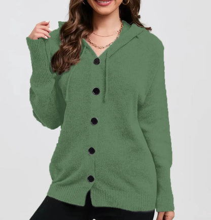 A woman wearing a loose, thick, hooded cotton cardigan in a solid colour.