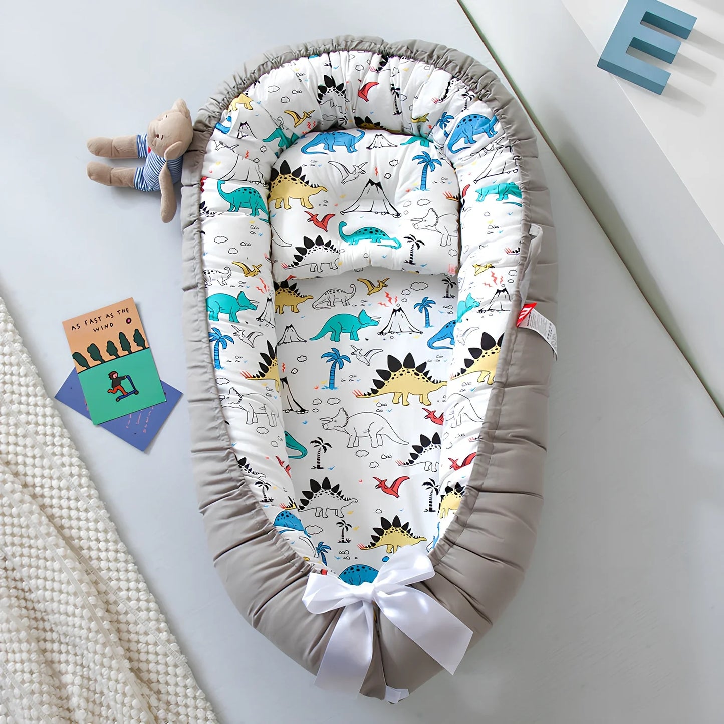 Portable foldable baby bed measuring 85x45cm with cartoon pattern, shown in green elk design