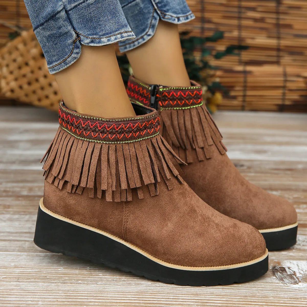 Women's thick bottom wedge bootie in suede with side zipper and tassel detail, available in multiple colours.