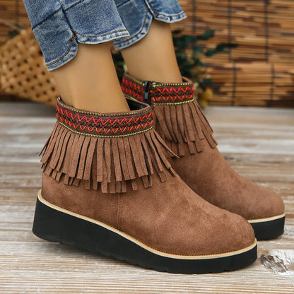 Women's thick bottom wedge bootie in suede with side zipper and tassel detail, available in multiple colours.