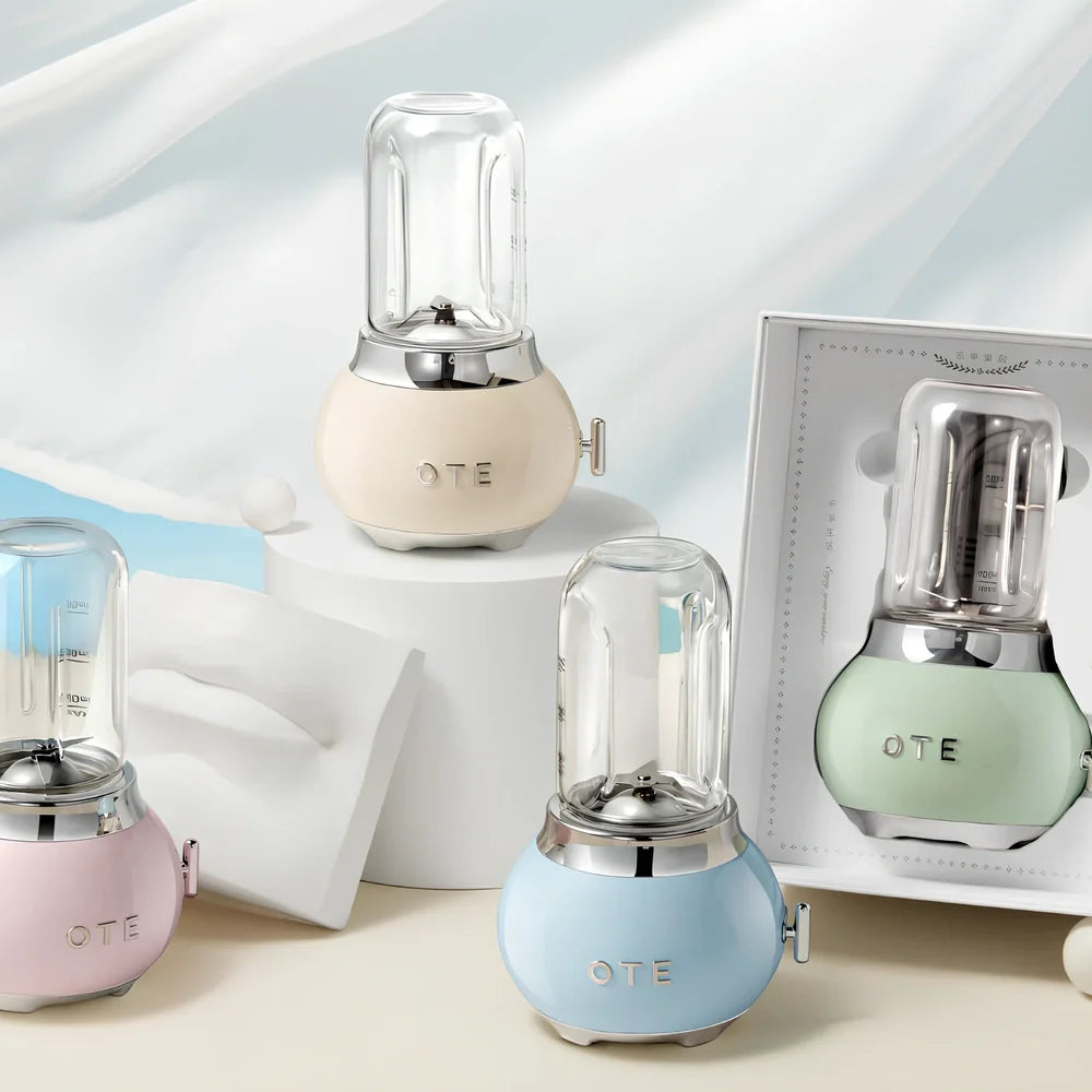 Small portable fruit juicer in blue with 400mL capacity cup and charging cable