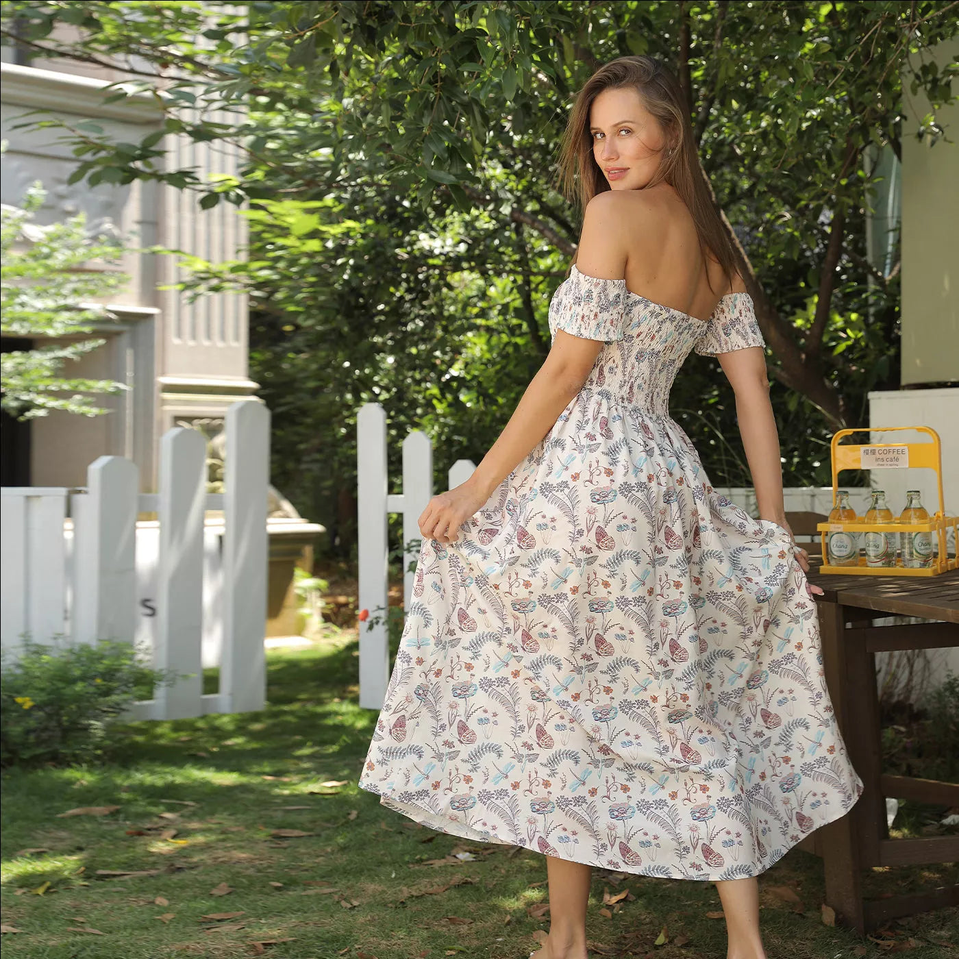 Women's off shoulder strapless floral dress in a lightweight fabric, available in multiple sizes.