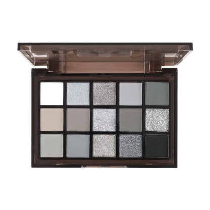 Open 15-colour eyeshadow palette showing shimmer and matte pans in browns, blues, and earth tones
