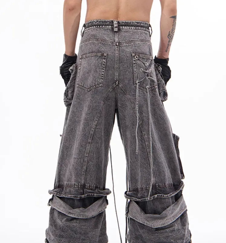 Grey distressed denim overalls with rope stitching on a man, showcasing the mop pant style.