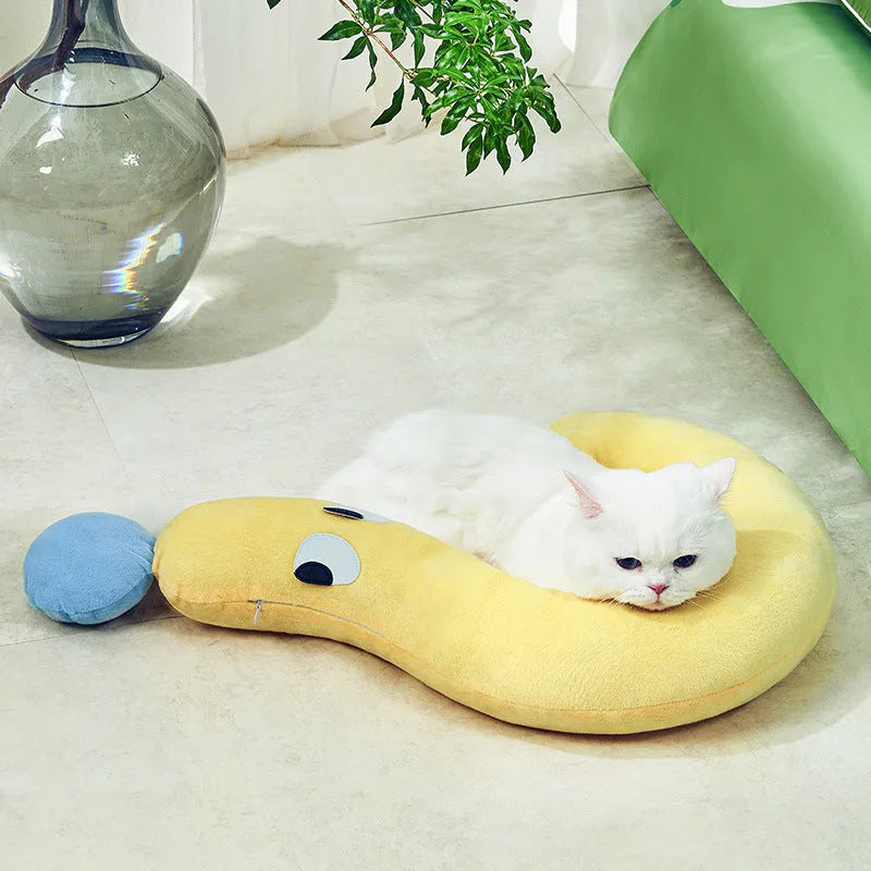Blue rectangular pet bed cushion pad on a wooden floor.