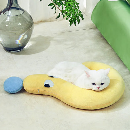 Blue rectangular pet bed cushion pad on a wooden floor.