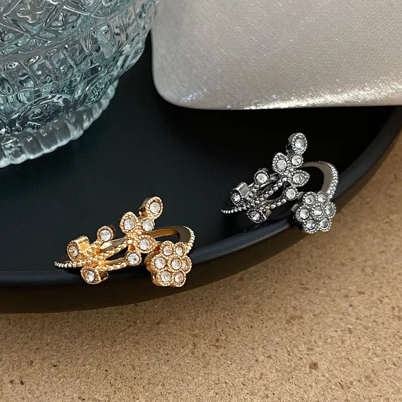 Women's copper open ring featuring a diamond-treated flower and leaf design available in gold and white colour finishes for a distinct niche accessory look.