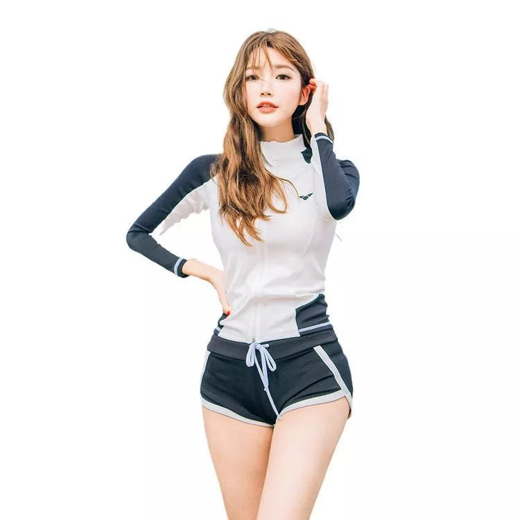 Couple in blue split swimsuits snorkeling in clear water