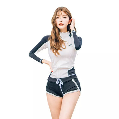 Couple in blue split swimsuits snorkeling in clear water