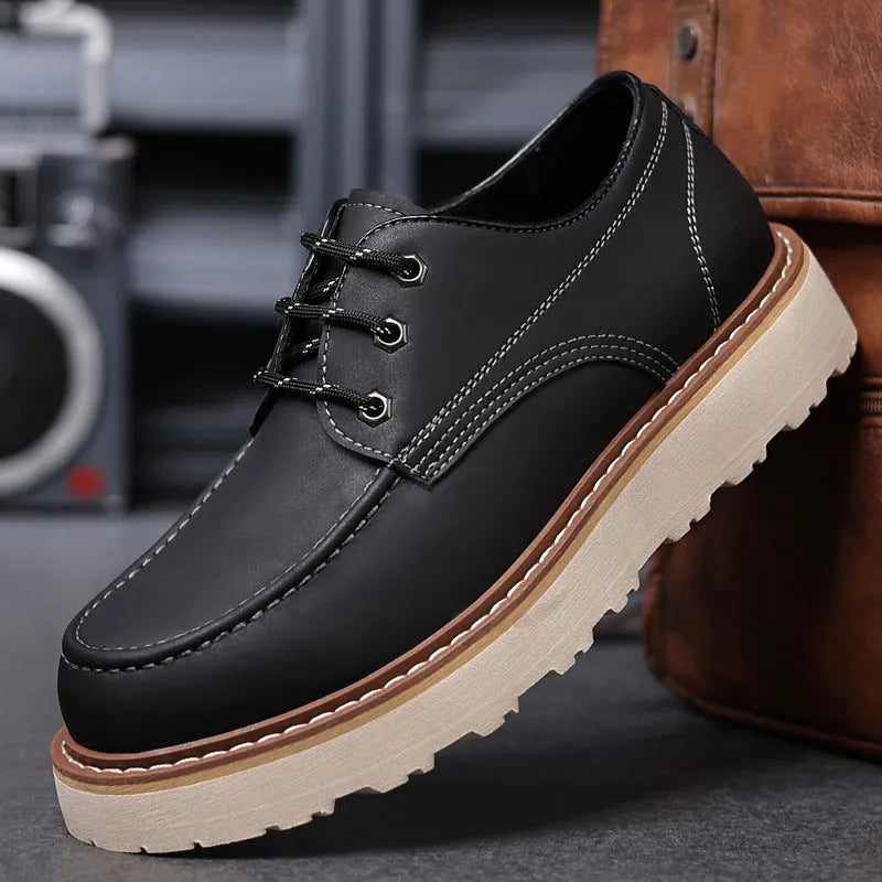 Men's black low-top Martin boots with a round toe and rubber sole on a white background.
