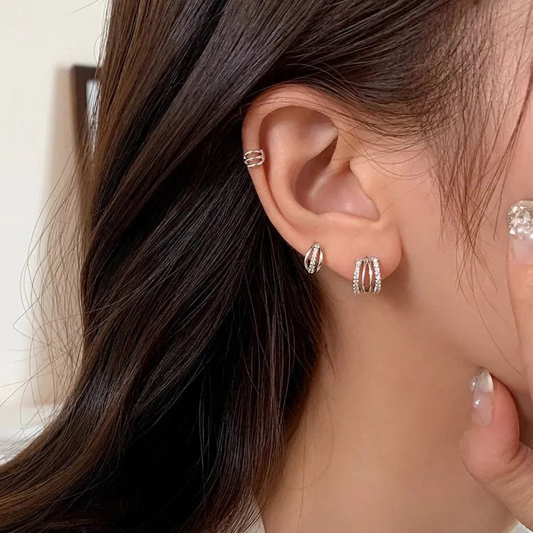 A pair of geometric-shaped 925 sterling silver earrings with a polished finish on a white background.