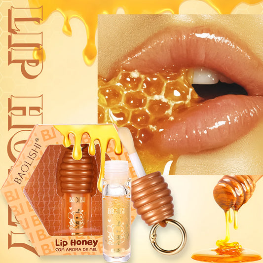 Moisturising honey lip gloss on a silver keychain against a plain background.