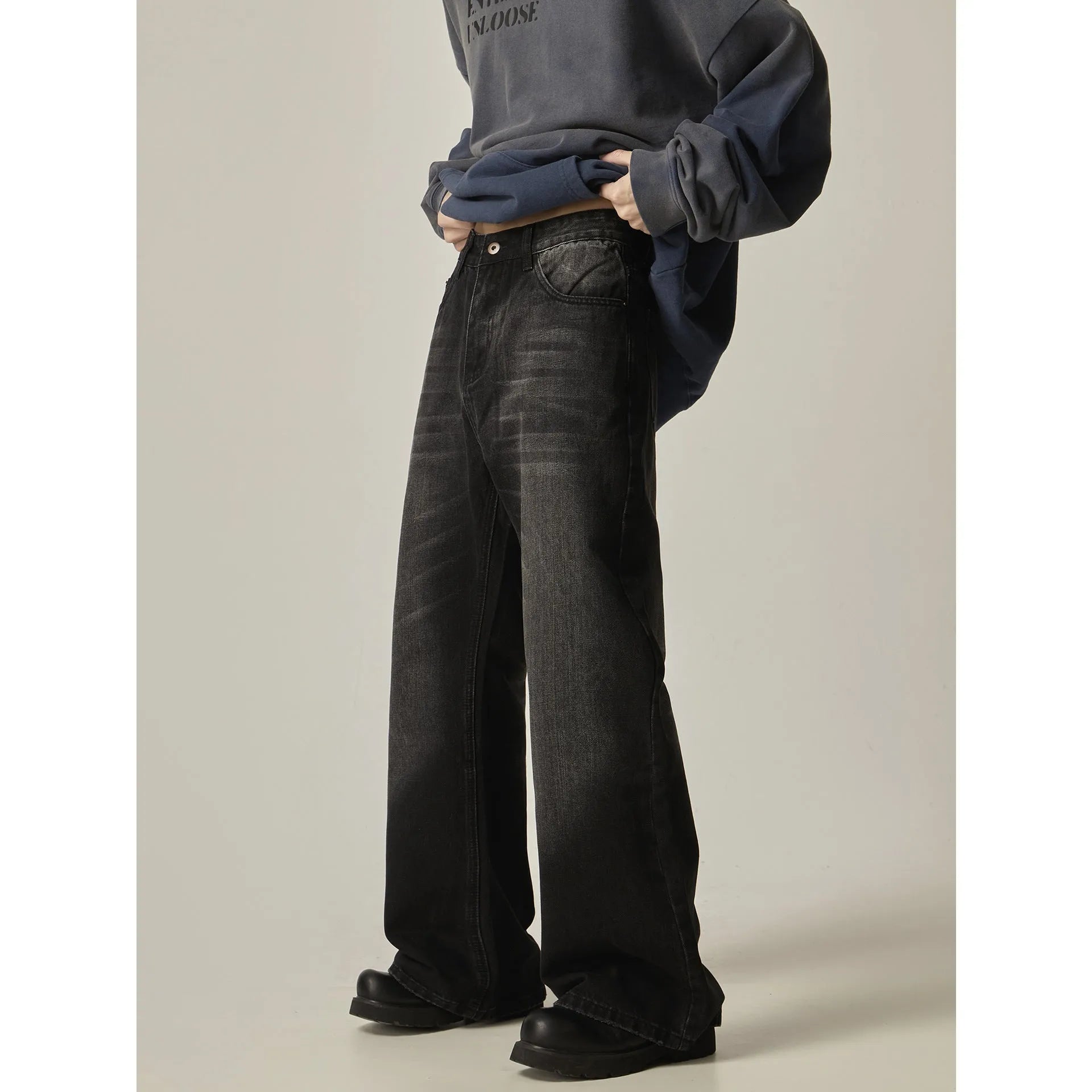 Black loose straight jeans with retro styling, zipper fly, and inelastic denim fabric