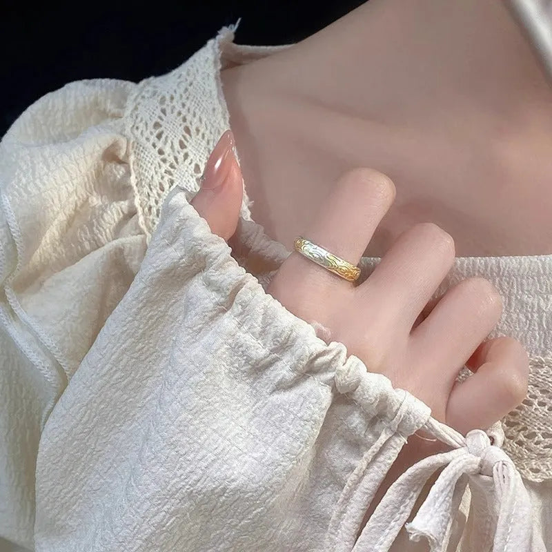 Open mouth silver and gold ring with J14 Xiangyun geometric pattern on a white copper band.