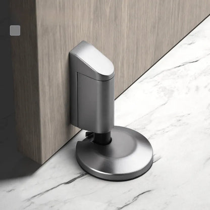 A modern invisible door stopper made from zinc alloy in a brushed gold finish.