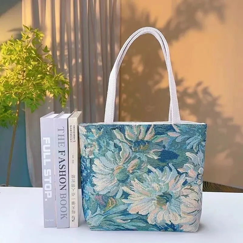 Colourful embroidered canvas shoulder bag with gold wire handles shown in small, medium, and large sizes.