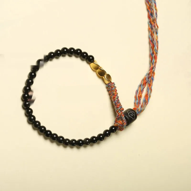 Hand-woven obsidian carrying strap showing woven texture and 4mm width