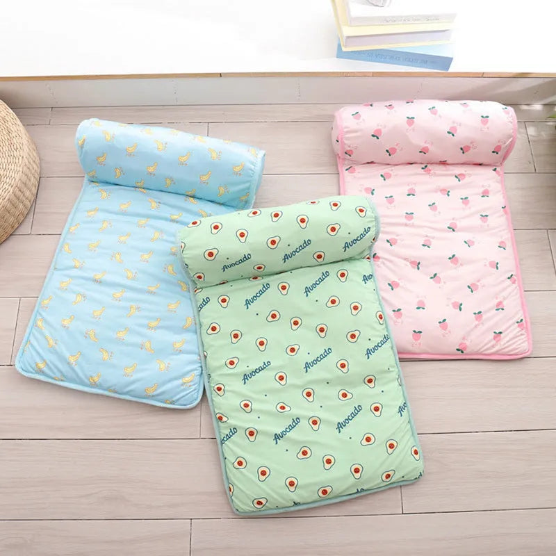 Pink blue green dog cooling mat on floor with pet, showing medium and large size options
