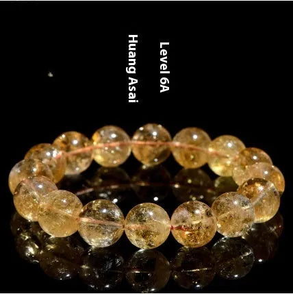 Natural yellow citrine bracelet with geometric beads in various sizes from 4mm to 20.8mm diameter on wrist