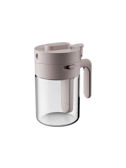 Small glass seasoning jars with lids and spoons in various colors for kitchen organization
