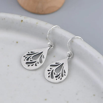Retro hollow water drop shaped earrings in 925 silver with a textured grinding finish.