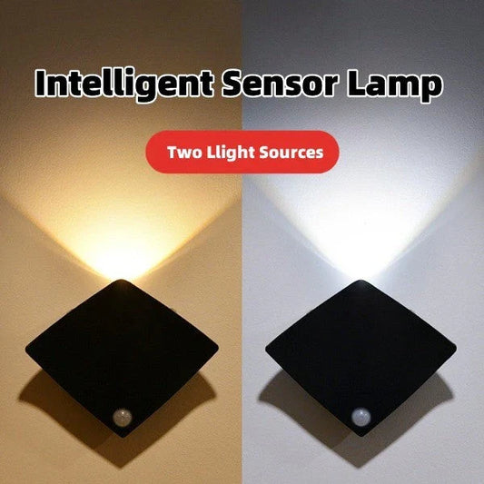 Wireless motion-activated wall lamp with USB recharging, available in black or white finish
