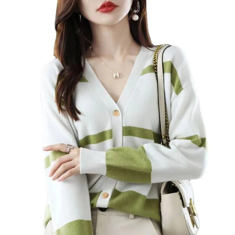 Women's black and white striped V-neck cardigan with buttons, showing a textured 3D knit pattern.