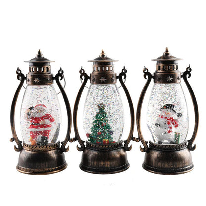 Crystal ball Christmas decoration with LED-lit paper snowman and elderly figures on desktop