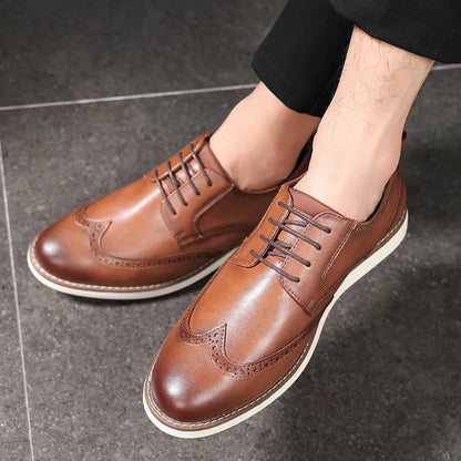 Men's black and brown slip-on business casual shoes with round toe and carved PU upper.