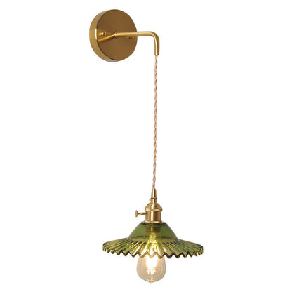 Retro brass lotus wall lamp with copper body and glass shade in various colours, mounted on a wall