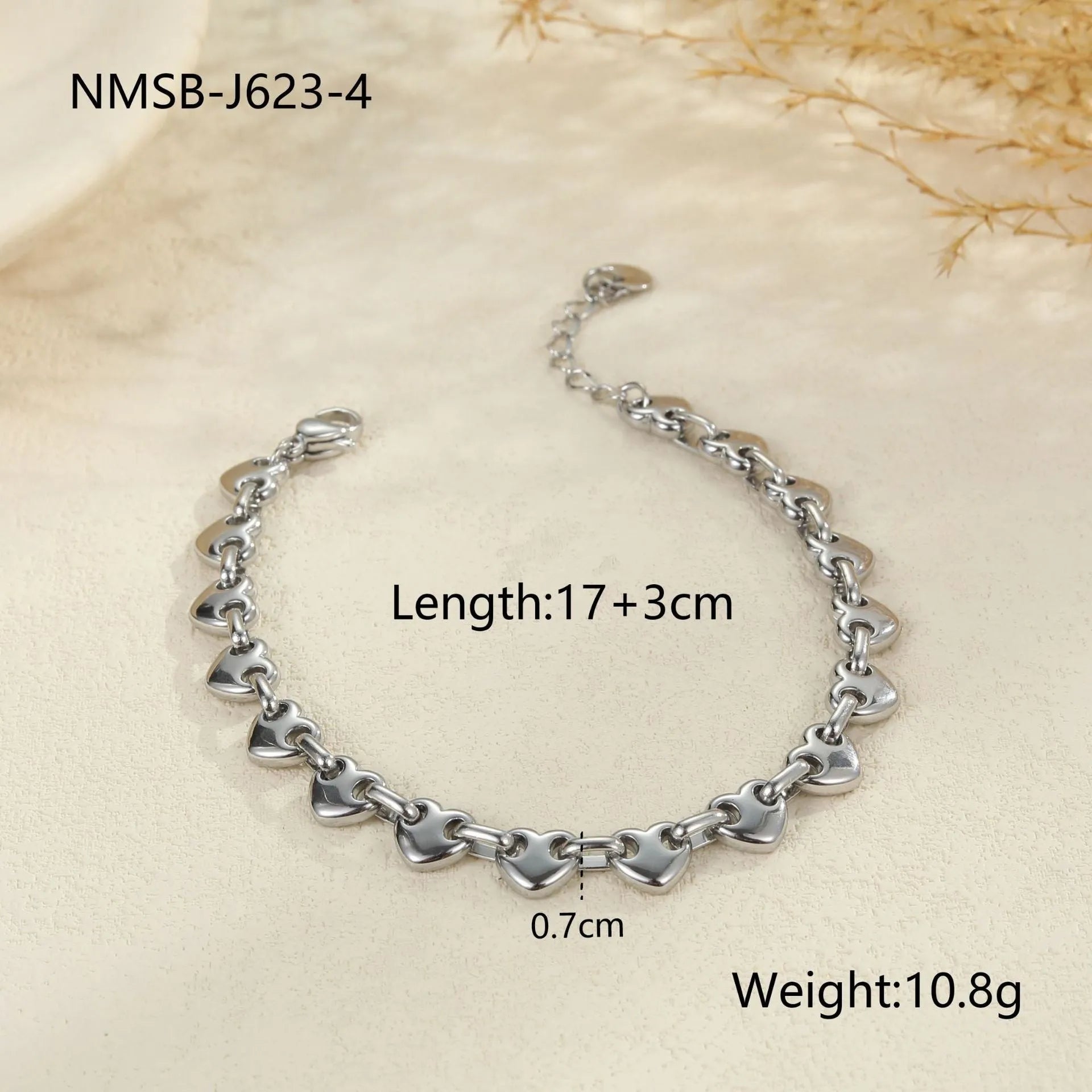 Women's hollow heart bracelet in stainless steel with 18K gold plating, shown in colour block, gold, and steel finishes