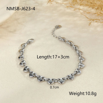 Women's hollow heart bracelet in stainless steel with 18K gold plating, shown in colour block, gold, and steel finishes