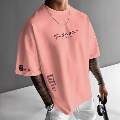 Men's round neck loose letter short sleeve T-shirt in polyester, shown in white, black, coral, and apricot