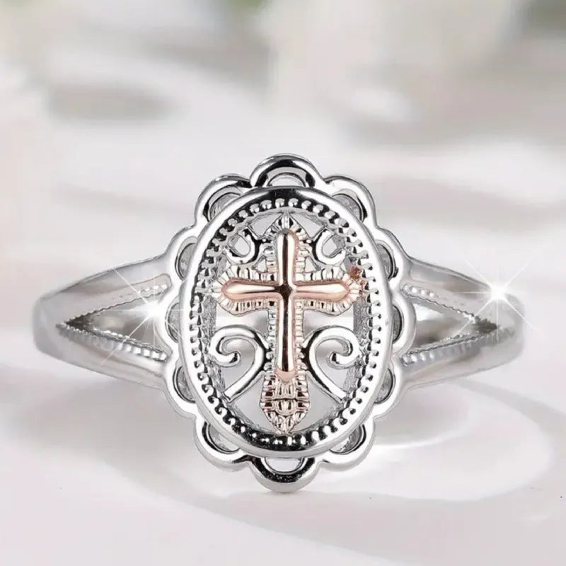 Silver colour women's cross lace ring on finger showing detailed design