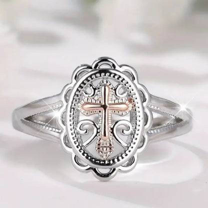Silver colour women's cross lace ring on finger showing detailed design