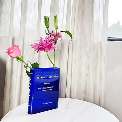 Transparent book-shaped acrylic vase, 22cm long with black font, refracting sunlight for home decor