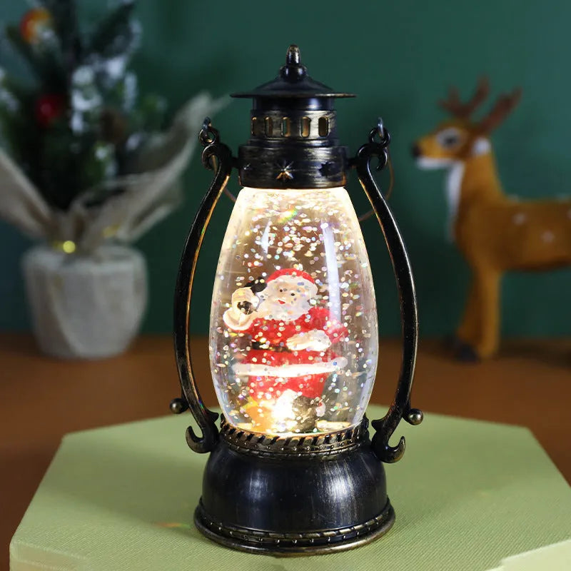 Crystal ball Christmas decoration with LED-lit paper snowman and elderly figures on desktop