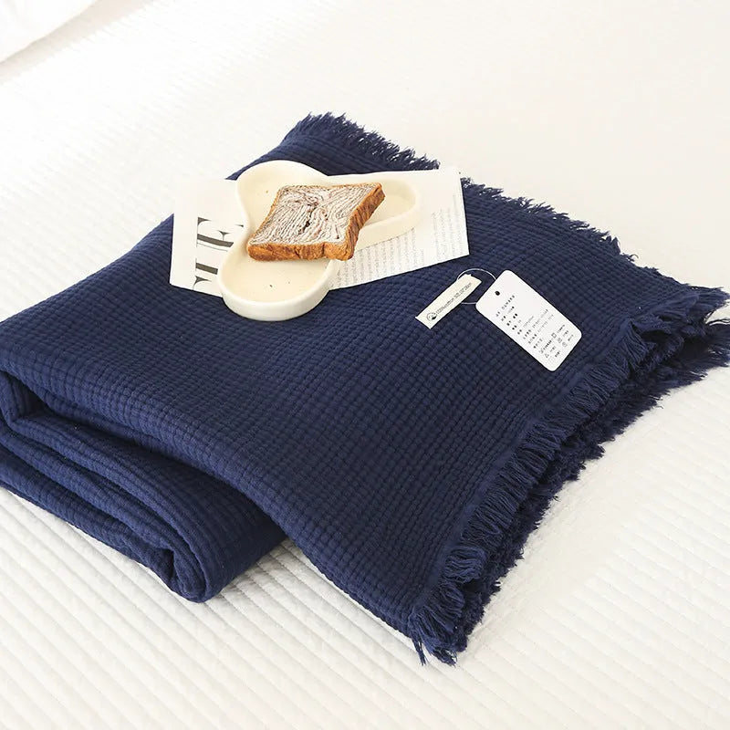 Four-layer gauze tassel blanket in cotton, showing tassel edges and textured fabric, available in multiple colours and sizes