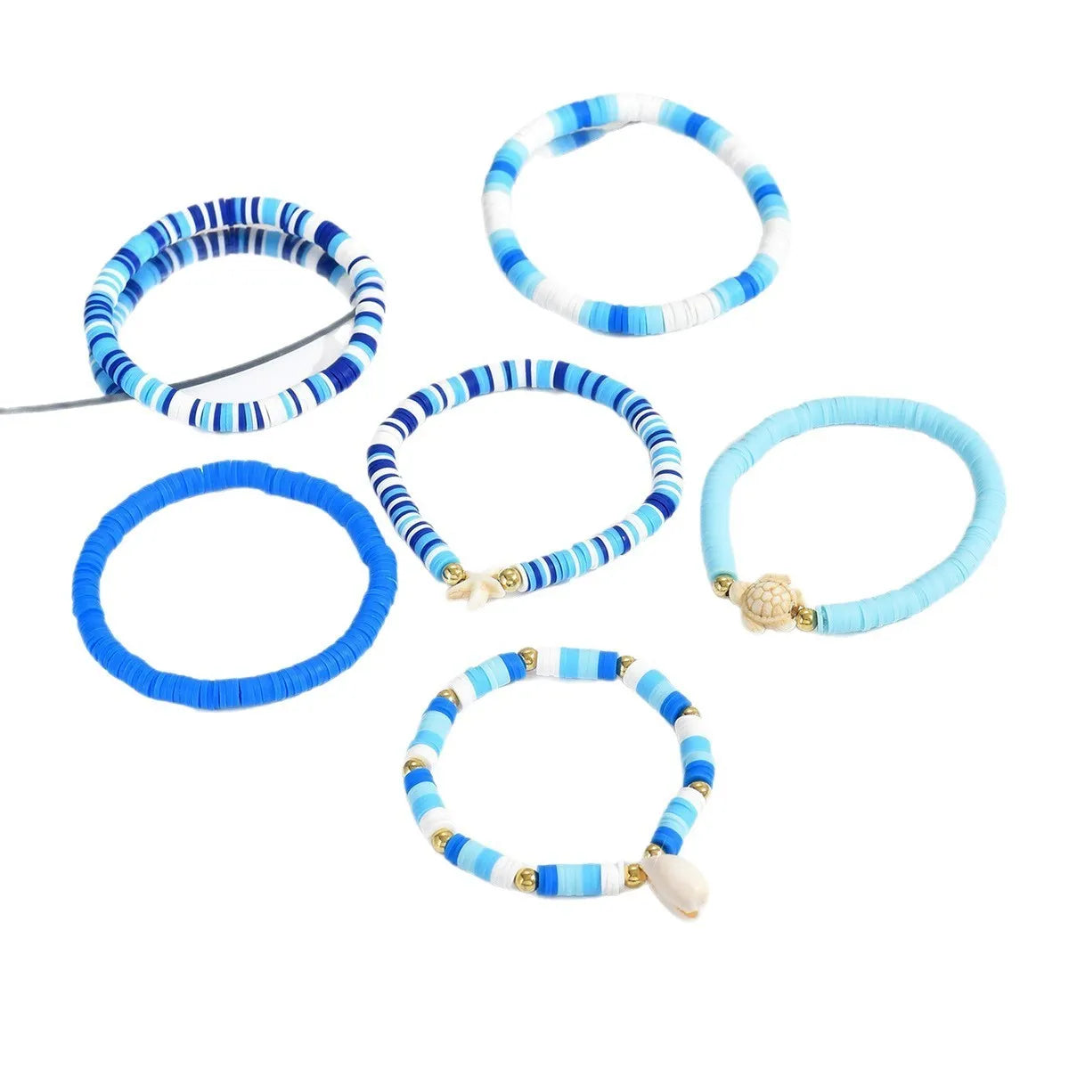 Six handmade polymer clay bracelets with geometric shell designs in bohemian blue colour