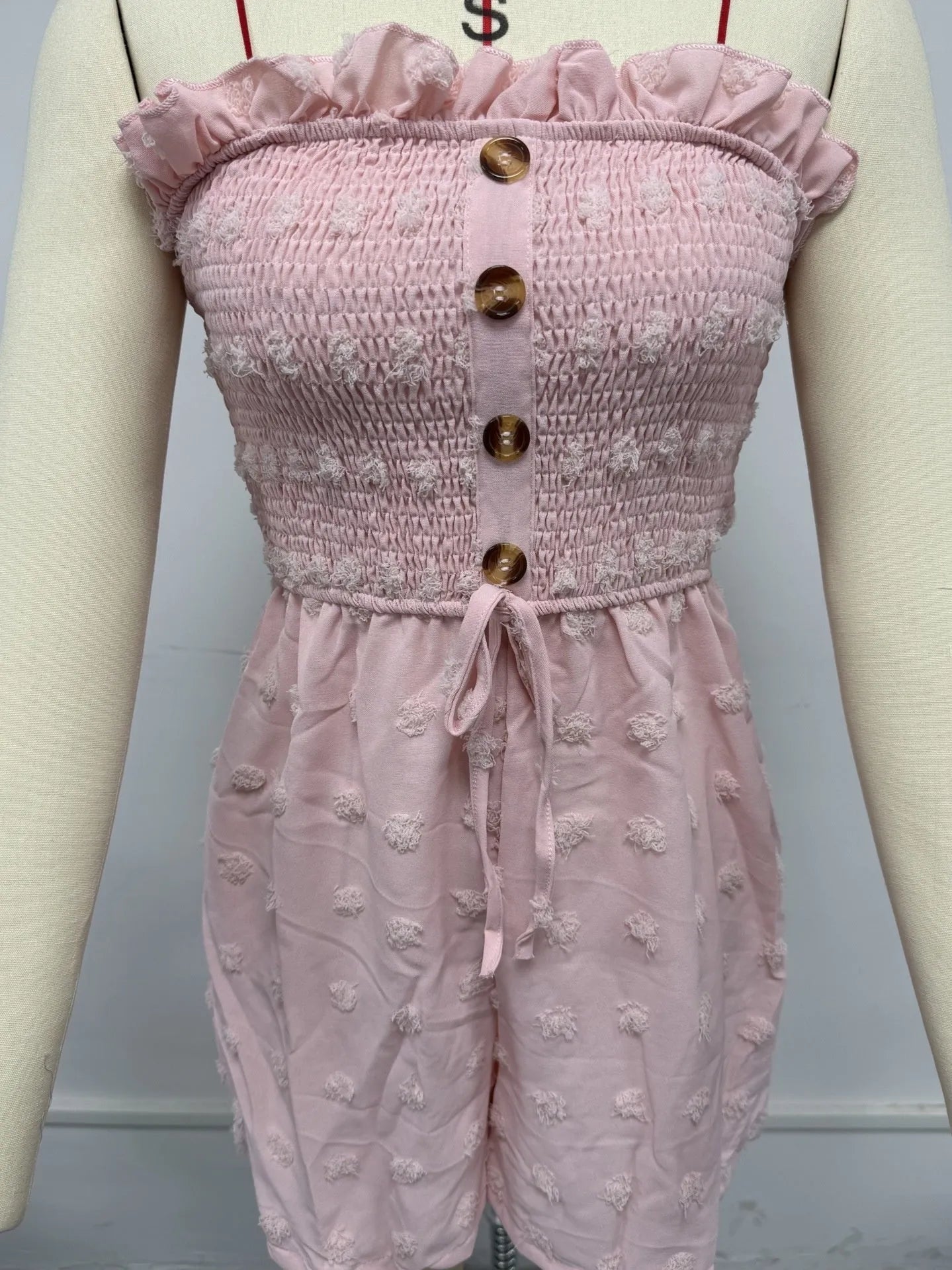 Women's off-shoulder sleeveless jumpsuit in polyester fabric with button detailing and mid-waist design